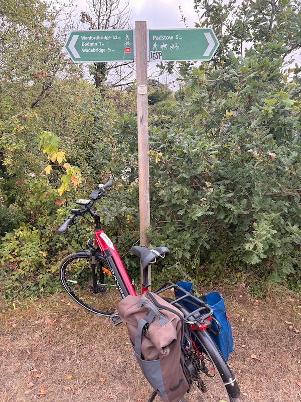 My bike with a sign pointing the five miles back to Padstow from Wadebridge. It’s 7 miles to Bodmin in the opposite direction.