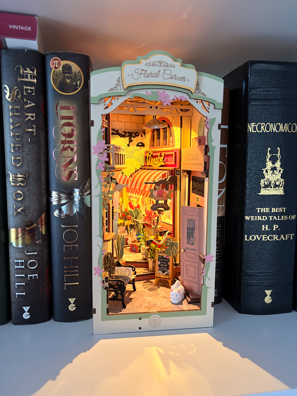 A floral book nook lit up on my bookshelves.