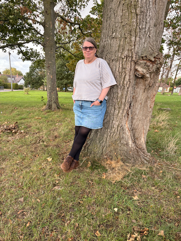 me, leaning on a tree wearing a nice beige/blue stripy t-shirt I just made
