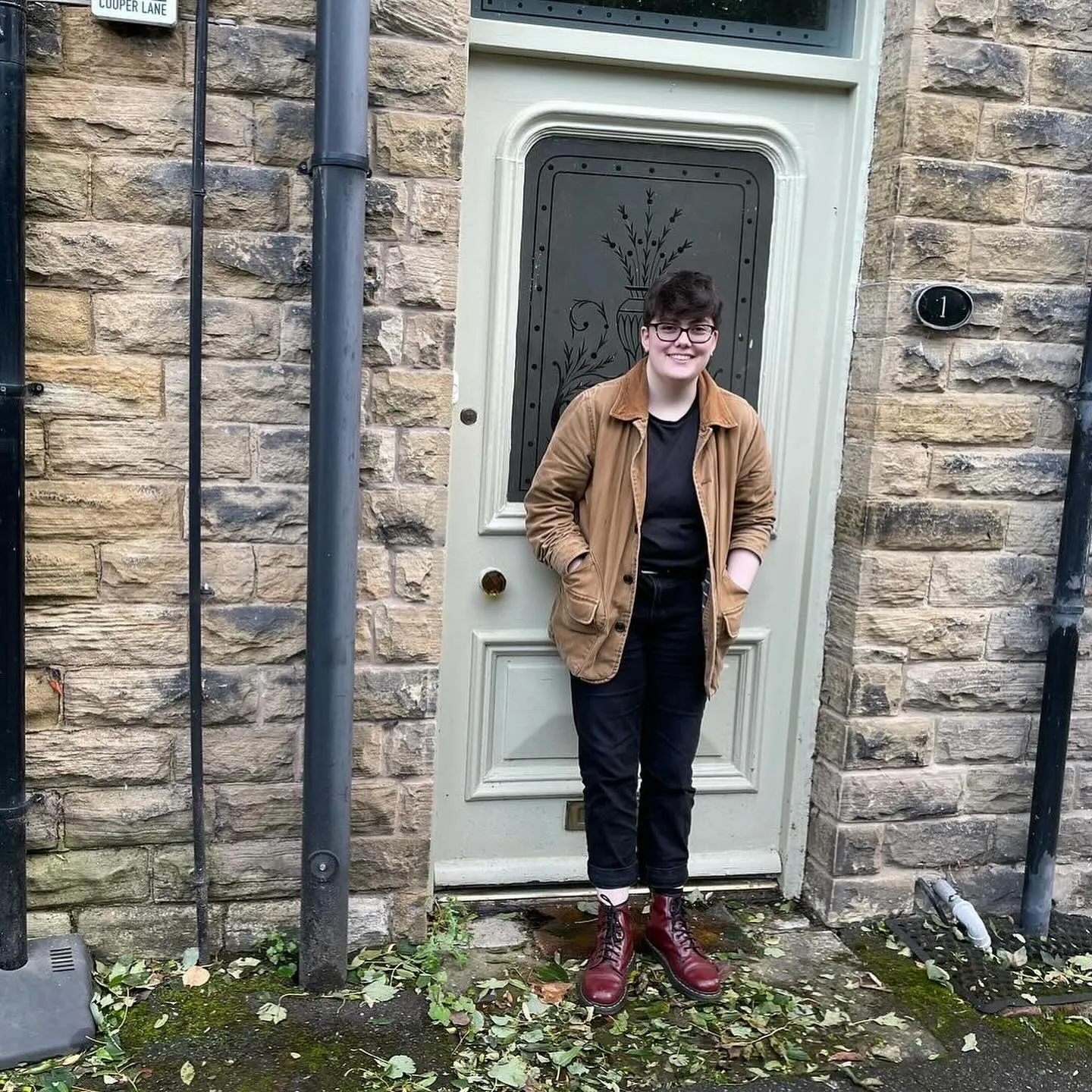 Miranda in front of the front door, university edition